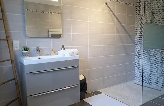 salle de bain avec sèche serviette, machine à laver, douche italienne