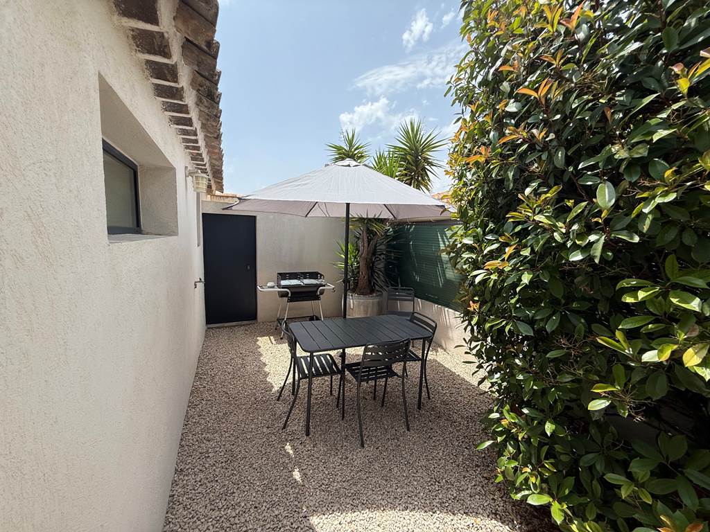 Coin repas ombragé avec barbecue pour des grillades conviviales