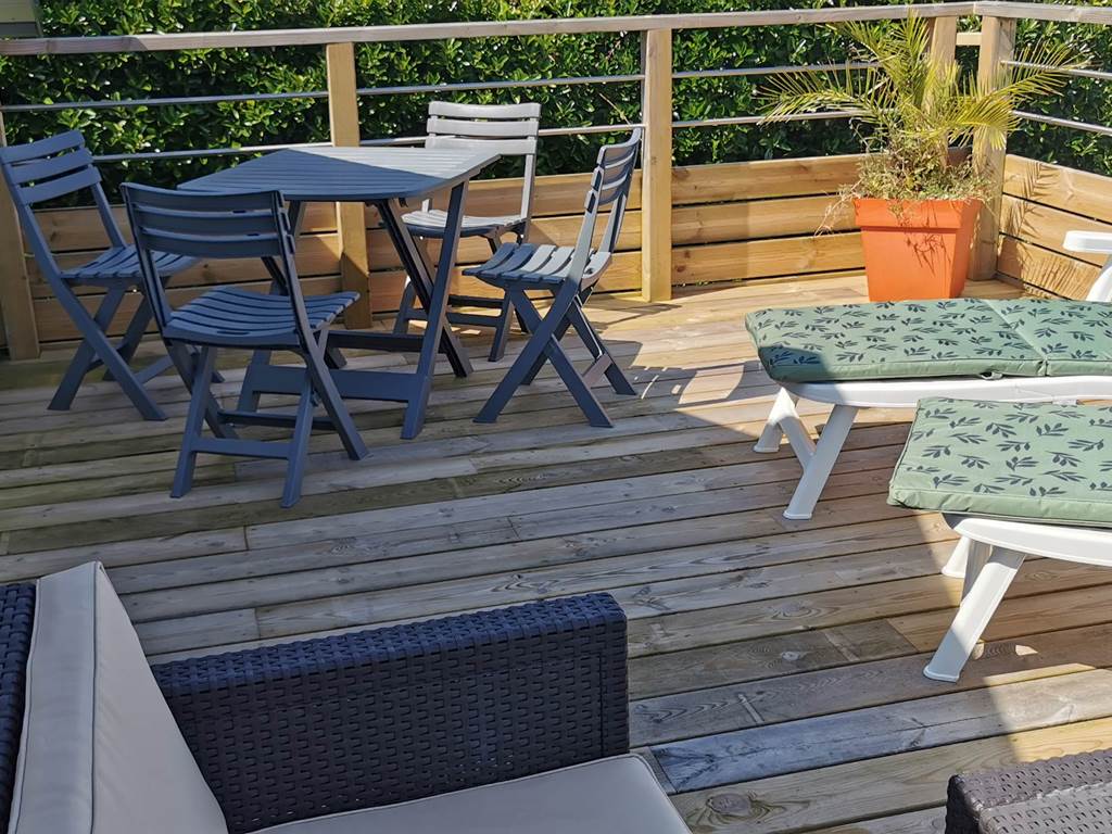 Terrasse solarium face à la mer avec transats, salon pour un séjour romantique