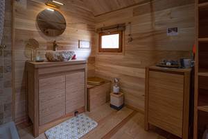Salle de bain avec douche, lavabo et toilette sèche dans le zôme