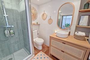 Ambiance douce et apaisante, avec des teintes verts d’eau, de bois clair et des touche de rotin, pour un esprit naturel et relaxant